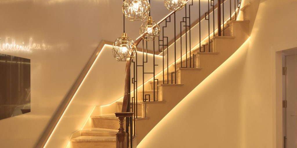 Stylish illuminated staircase with warm LED lights.