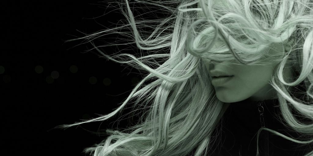woman with white hair in black shirt