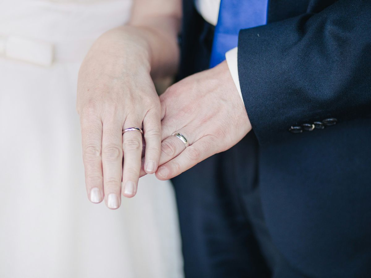 couple wearing their band rings