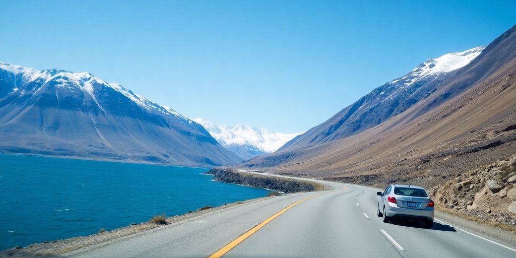 A car on a scenic coastal highway near Anchorage, Alaska.