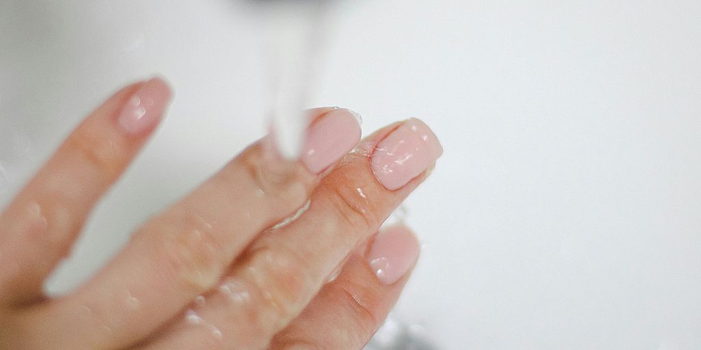 a close-up of a person's hand holding a tube