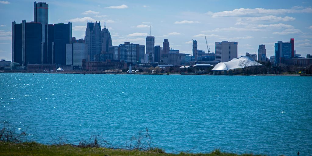 a large body of water with a city in the background