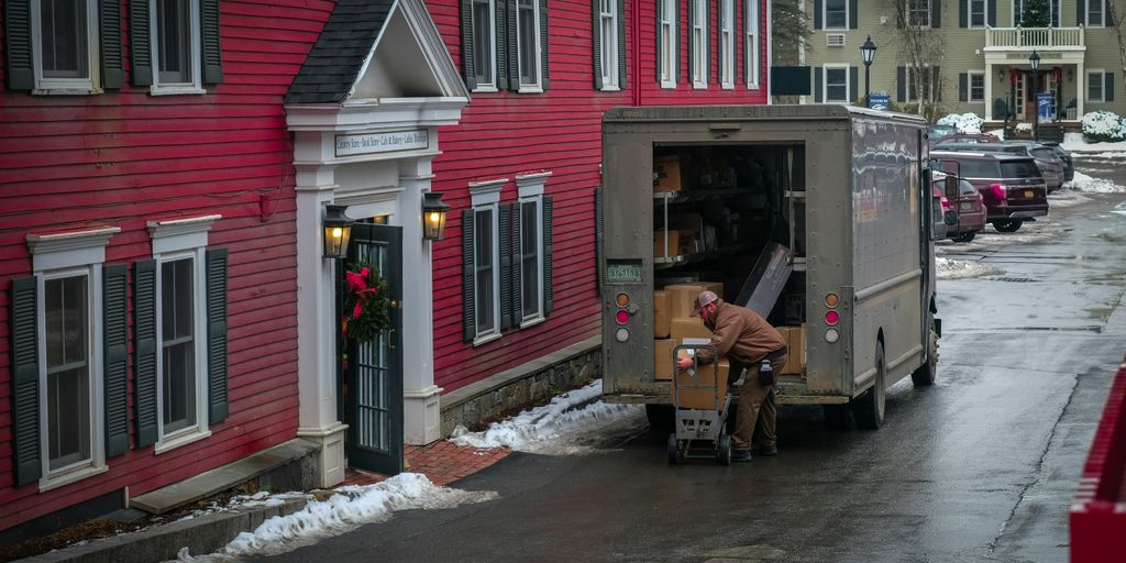 a person loading a van with flowers