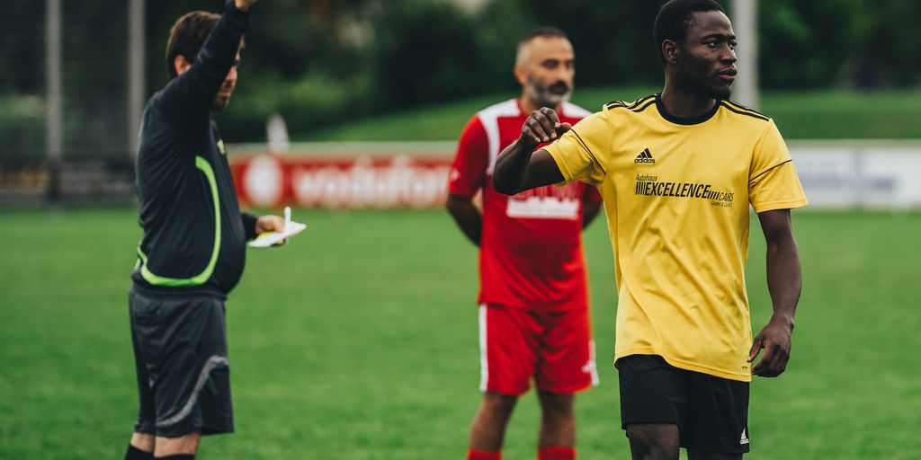 man in black long sleeve shirt holding yellow plastic cup
