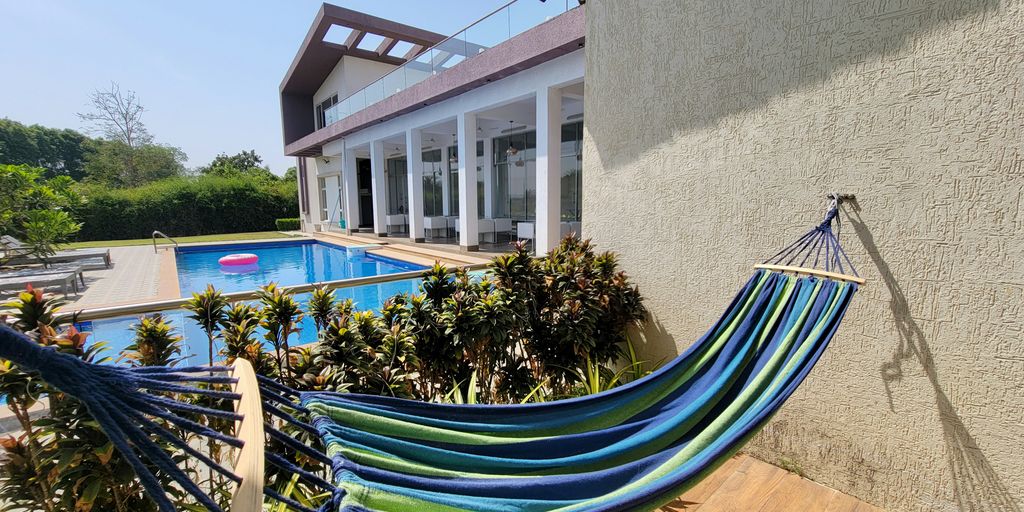 a blue hammock sitting in front of a house