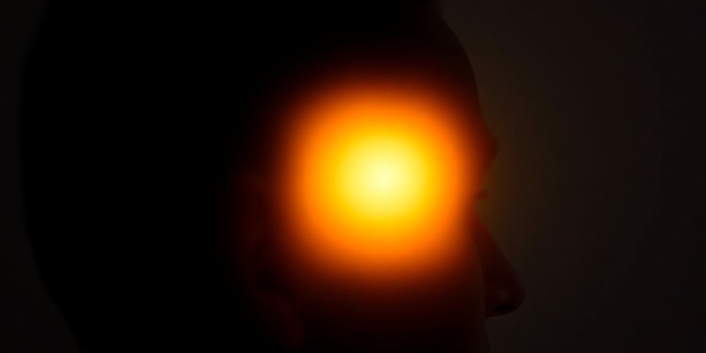Person's head with glowing brain
