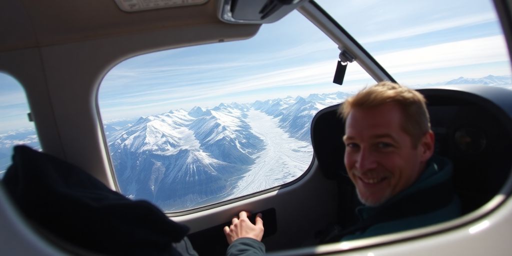 A pilot flies a small plane over snowy Alaskan mountains.