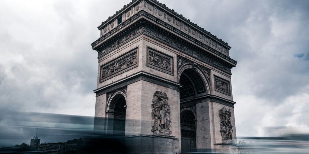 a very tall tower with a clock on it's side