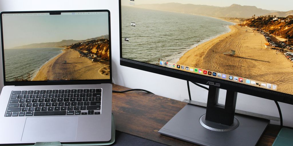 a laptop computer sitting on top of a wooden desk