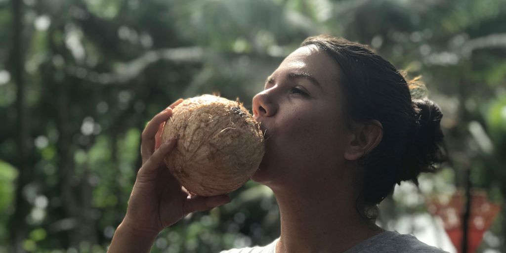 woman drinking coconut juice