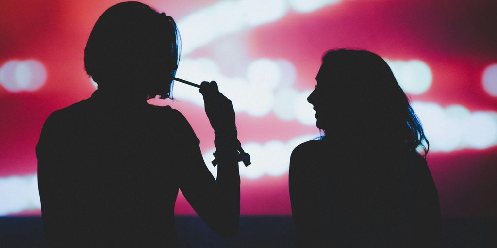 silhouette of woman holding microphone